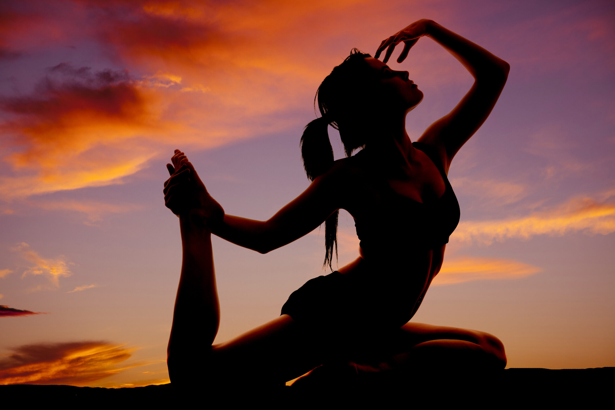woman in yoga pose outdoors at sunset sanskrit blog