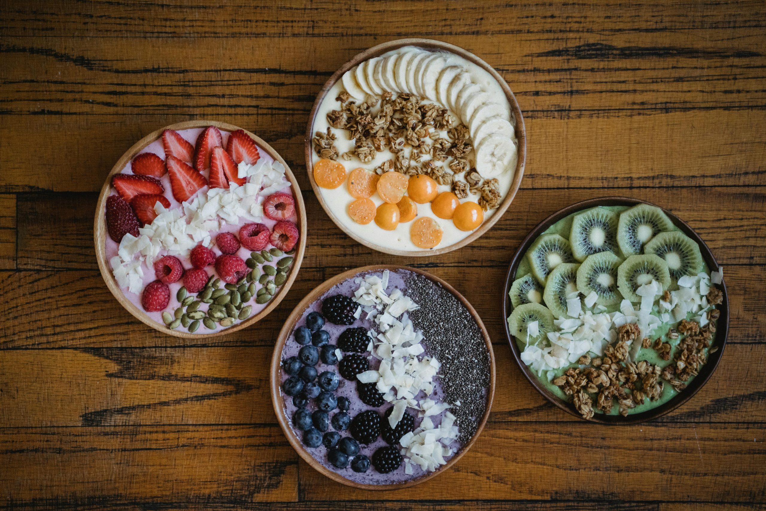 bowls with fruit, granola, and seeds